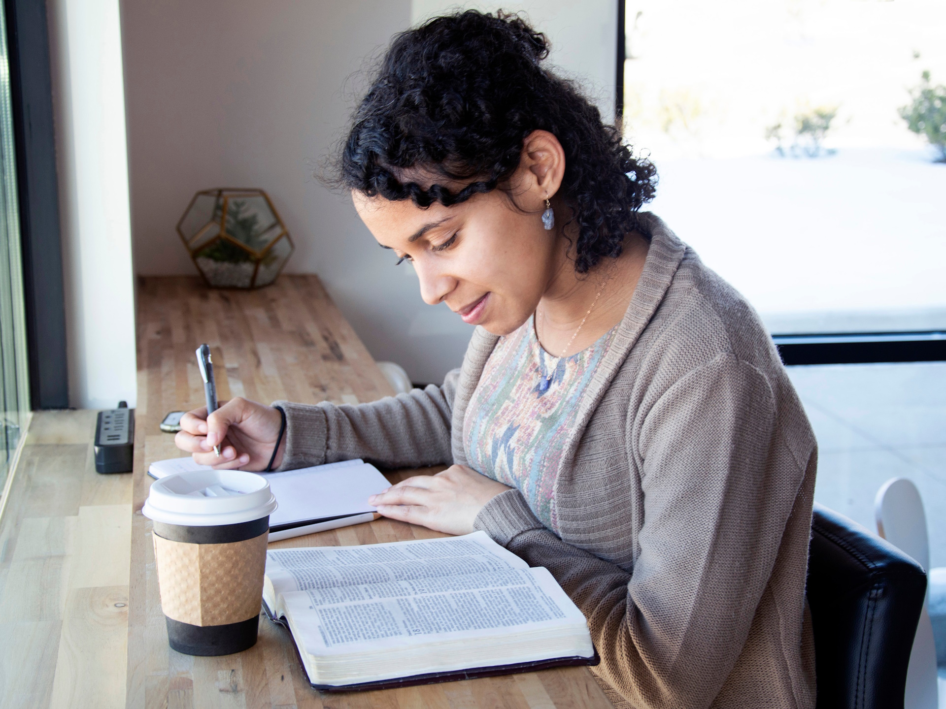 a woman pleasantly reading her Bible